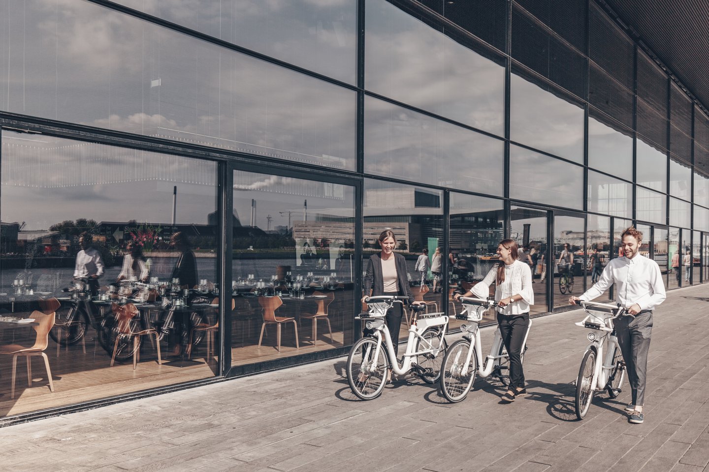 People walking outside the Royal Danish Playhouse "Skuespilhuset" with city bikes, Copenhagen