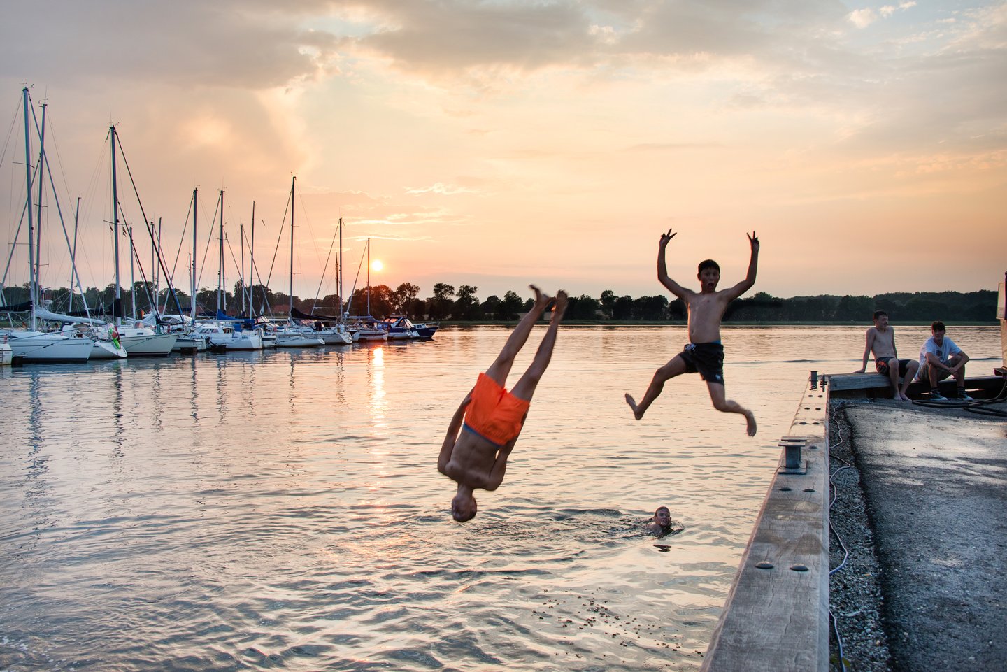 Children jumping in Water at Præstø Havn, Zealand