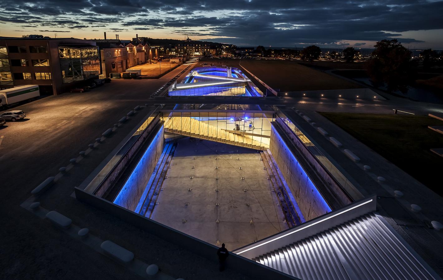 The Danish Maritime Museum in Helsingør, Denmark, lit up at night with neon lights