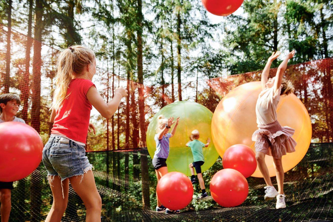Kinder spielen mit Riesenbällen im WOW Park in Billund