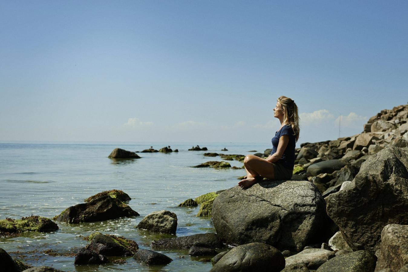 Lady sat relaxing on a beach in Bornholm