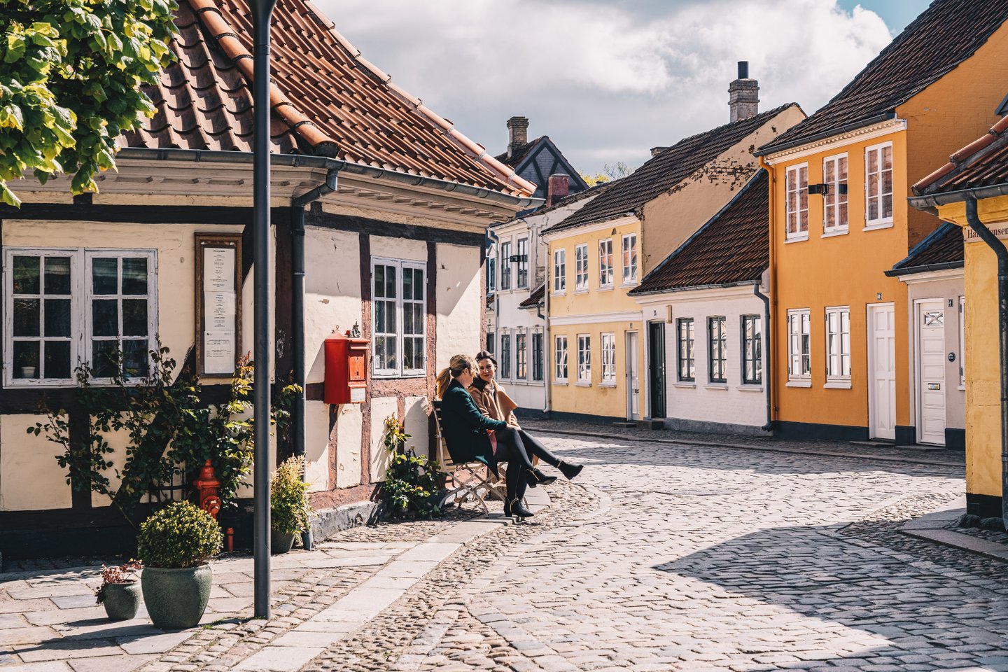 Women sitting on a bench in old town of Odense on Fyn