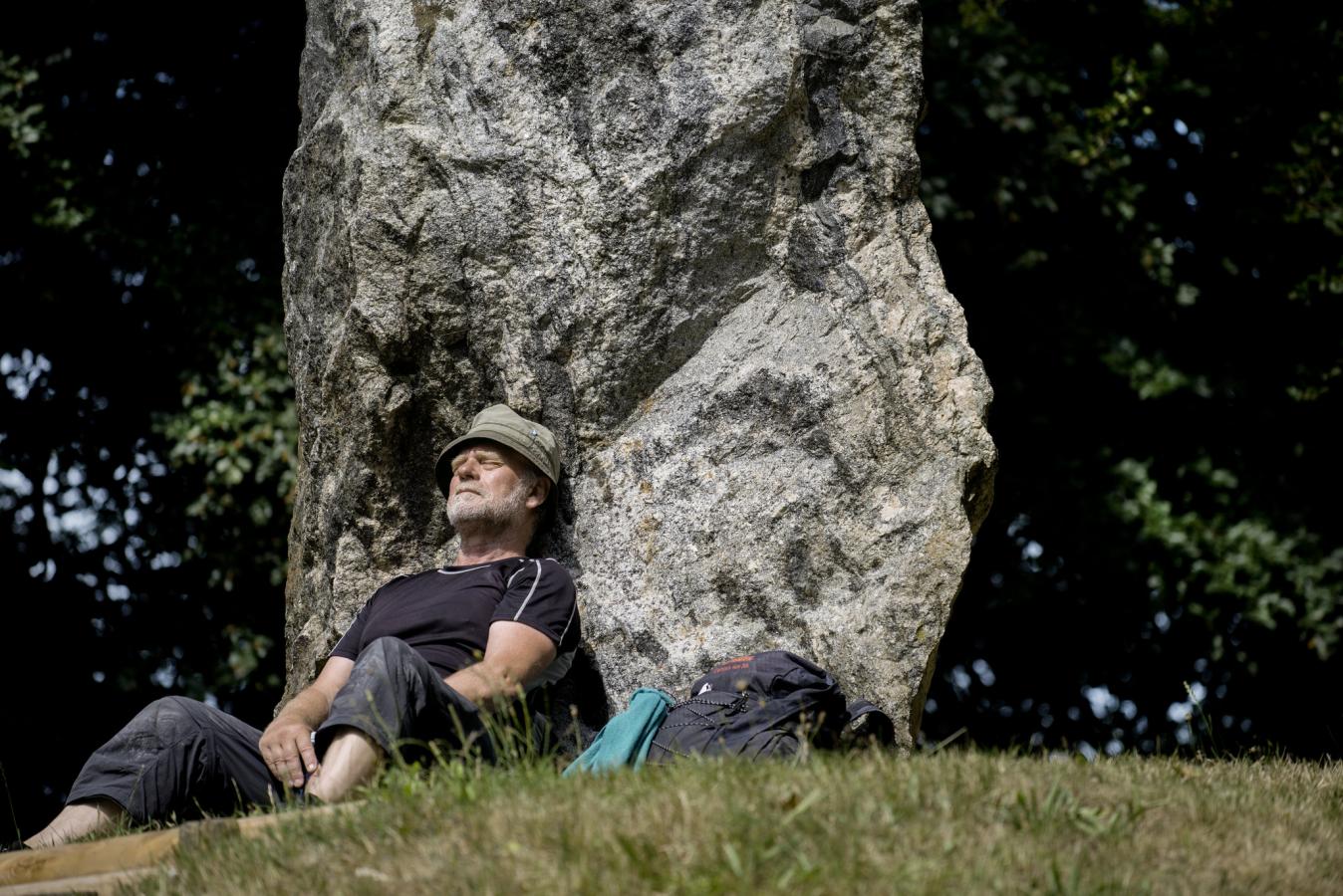 Wanderer macht Rast am Denkmal Skibelund Krat auf dem dänischen Pilgerweg Heerweg