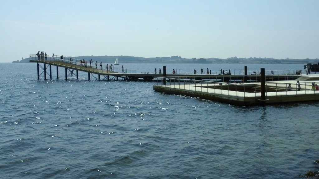 People enjoying the water at Faaborg Harbour Baths in Denmark