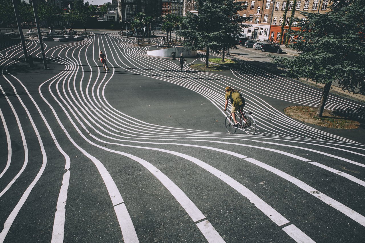 A cyclist speeds down the hill at Superkilen, Copenhagen, Denmark