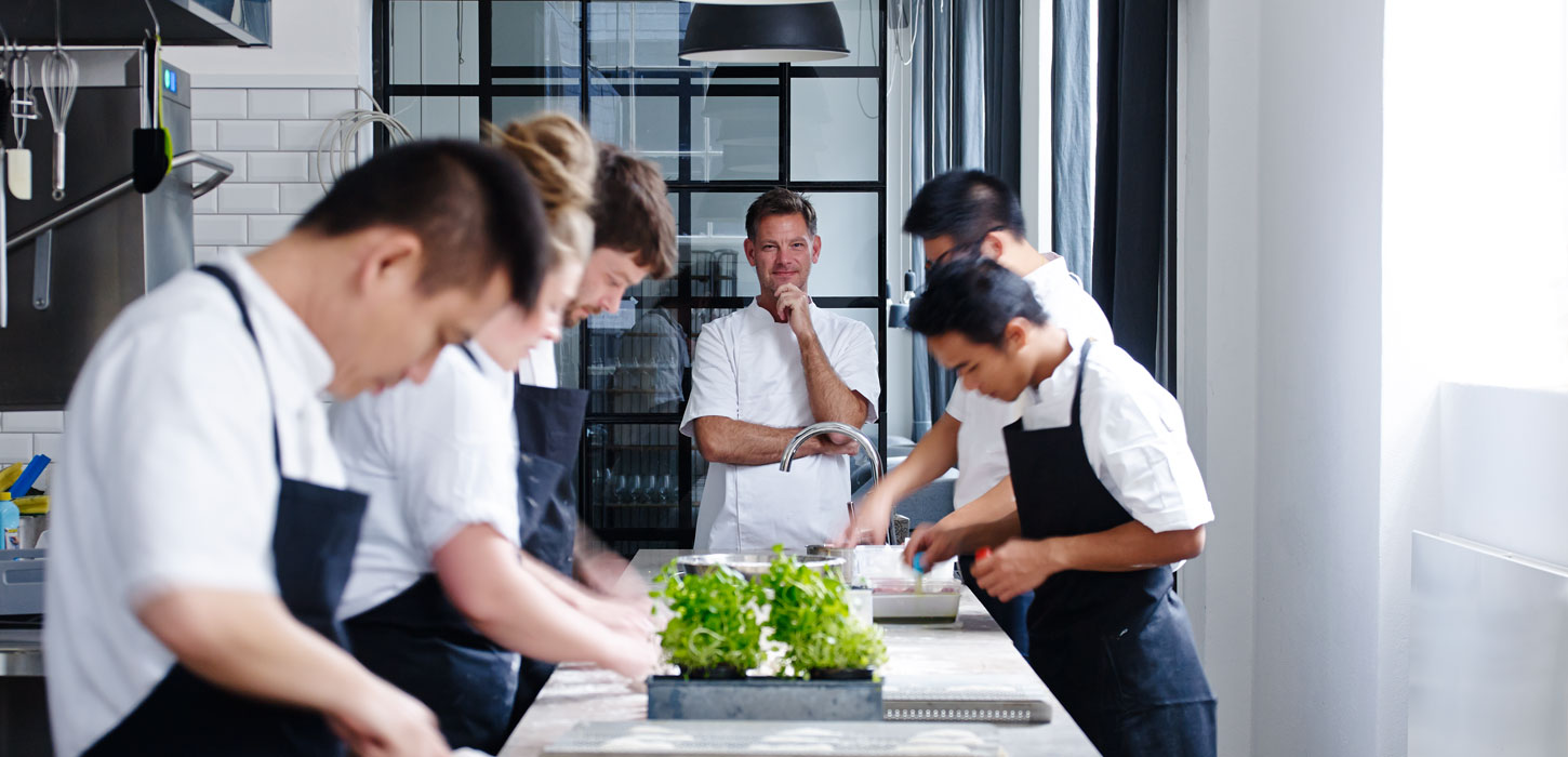 Chefs prepare food in the kitchen at VeVe, a restaurant in Copenhagen, Denmark