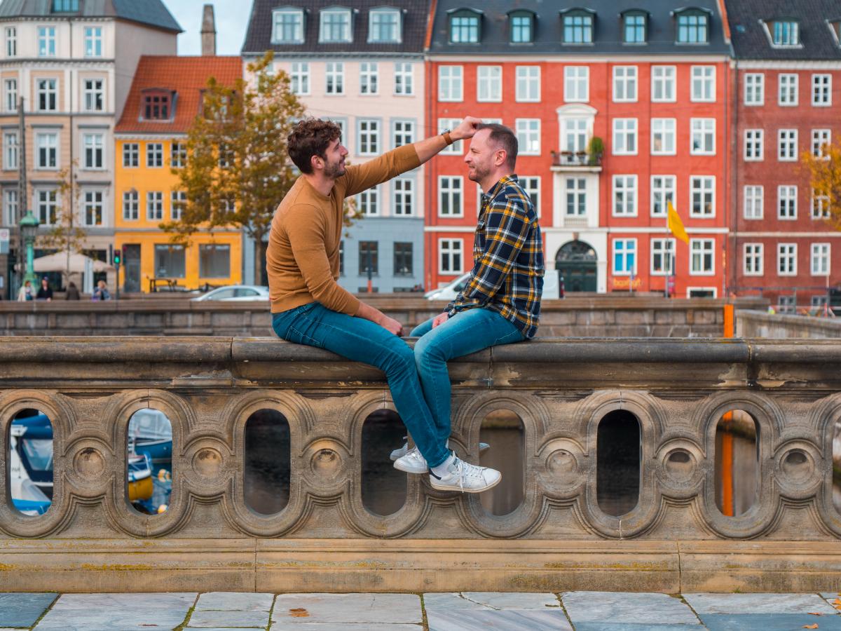 Gay couple sits at the canals in Copenhagen