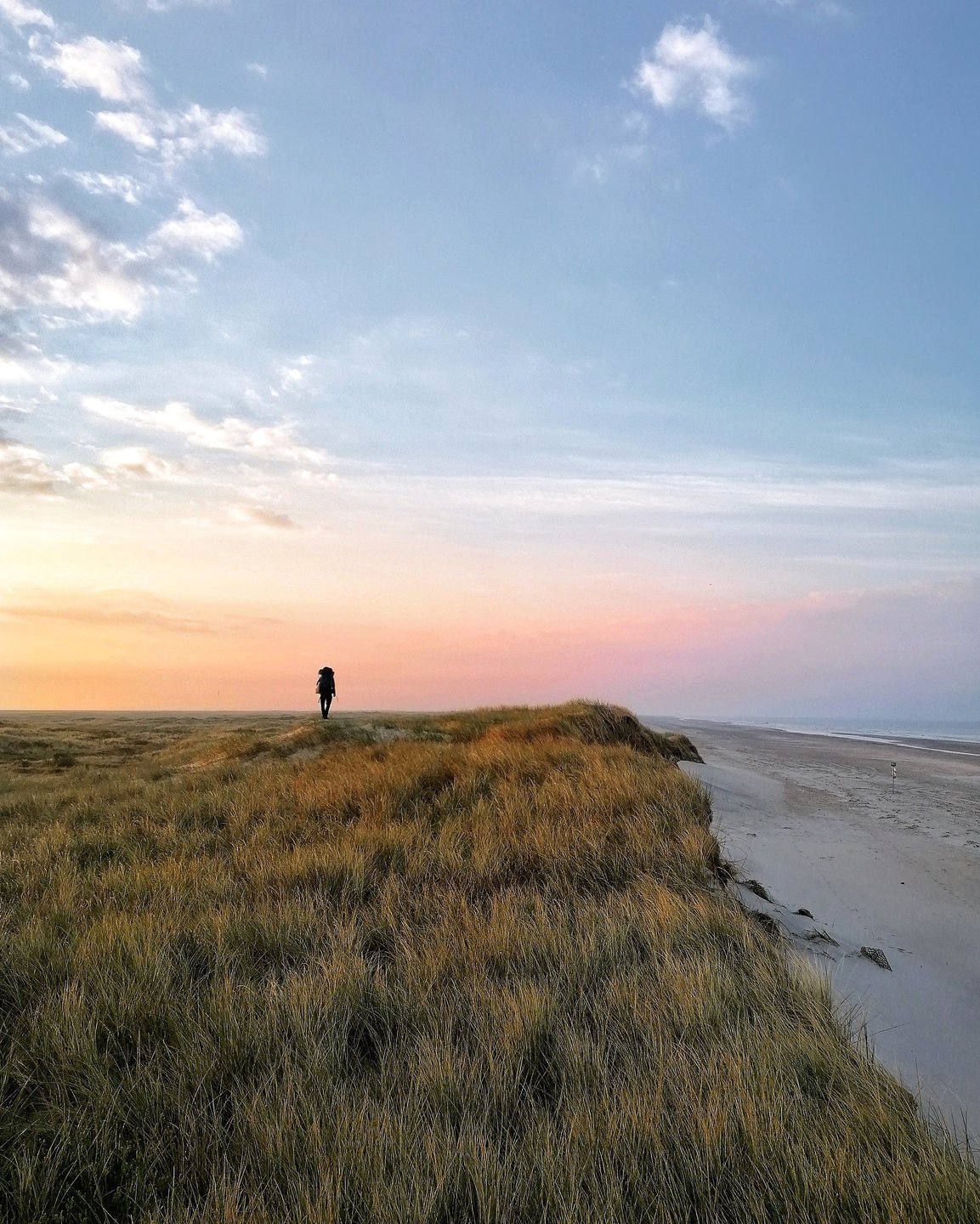 A person hiking along Skallingen on the West coast.