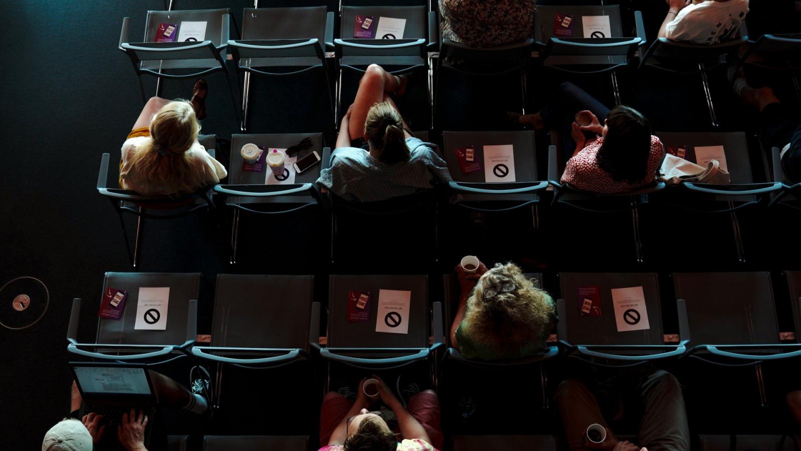 Business events - people sit in a venue with social distance because of coronavirus - Copenhagen, Denmark