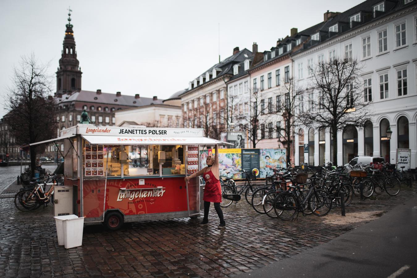 Woman opening hot dog stand "Jeanettes Pølser" in Copenhagen