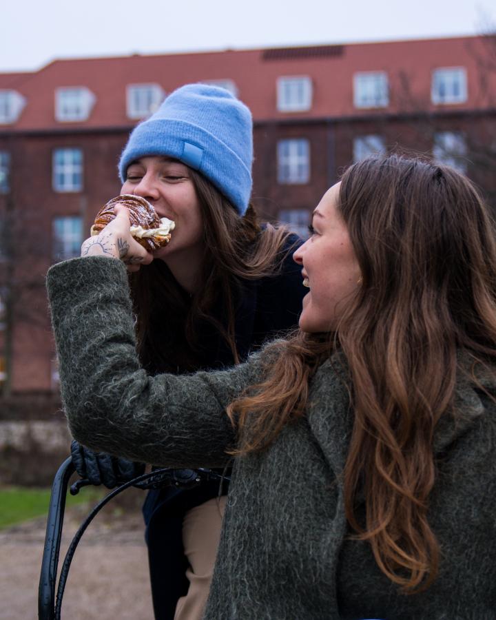 Person biting in Fastelavnsbolle in Copenhagen 