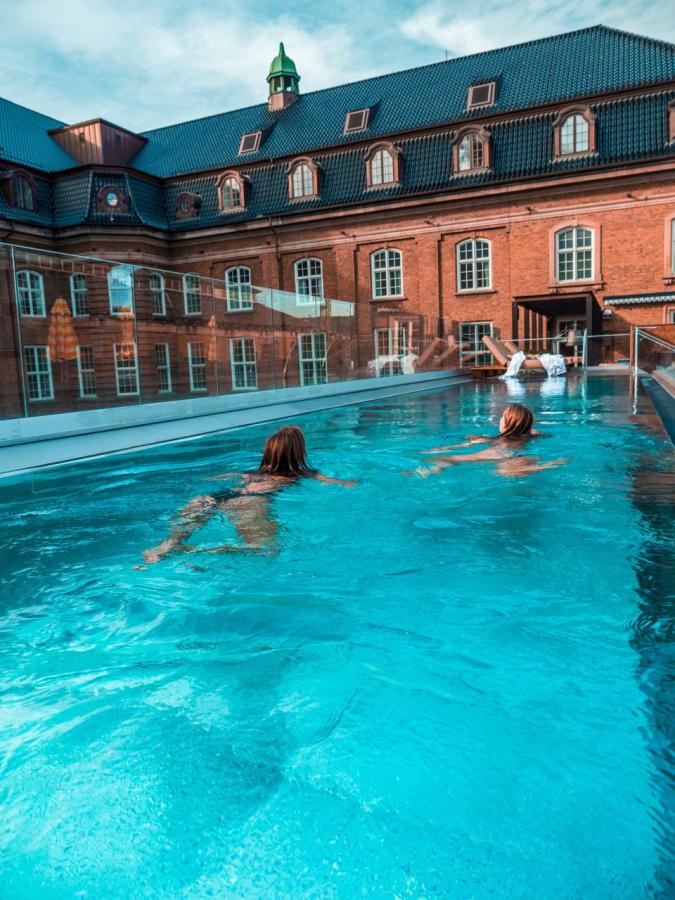 People swimming in luxury hotel Villa Copenhagen's rooftop swimming pool, Copenhagen, Denmark