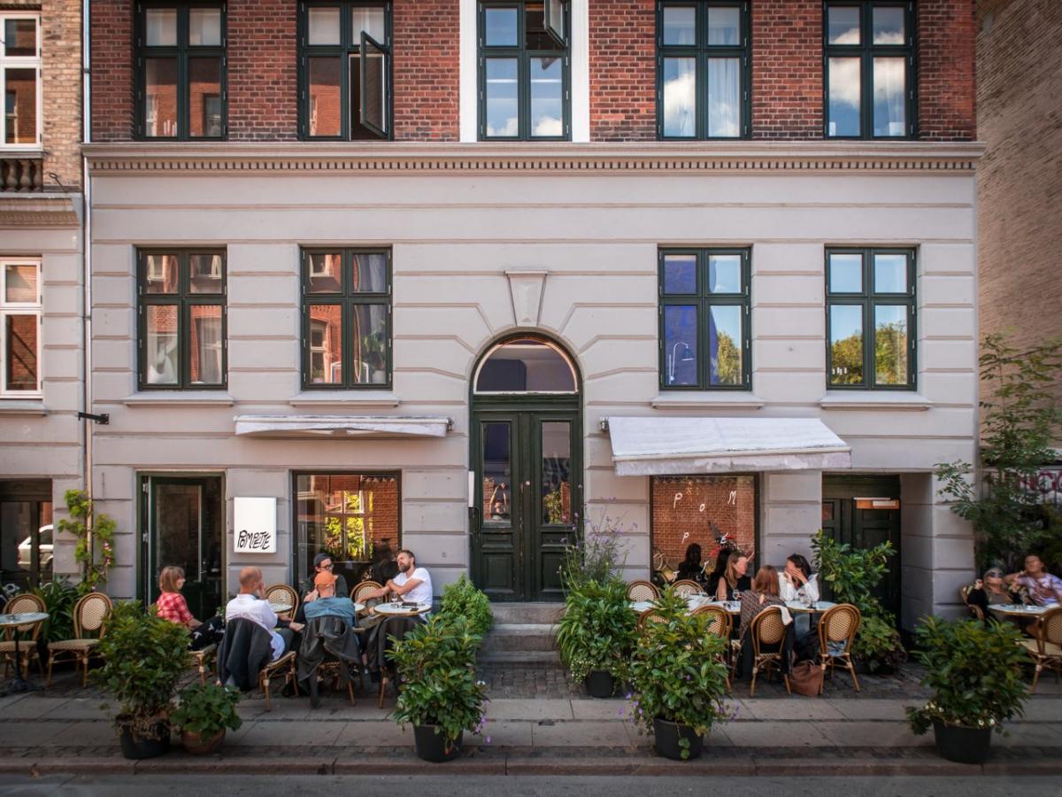 People sitting outside the winebar Pompette, a bar in central Copenhagen, Denmark