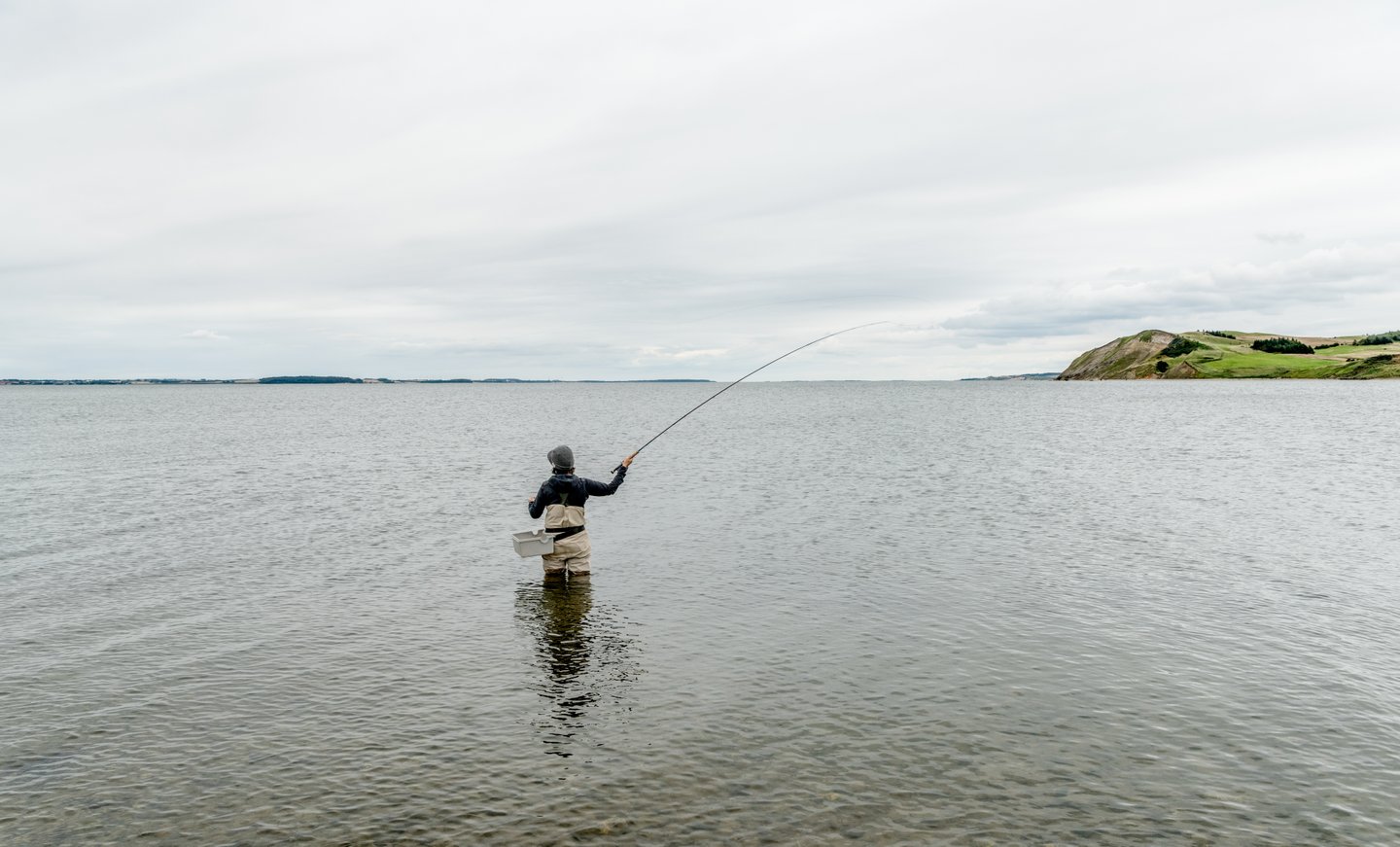 Fisher standing in the ocean, Mors, Northjutland