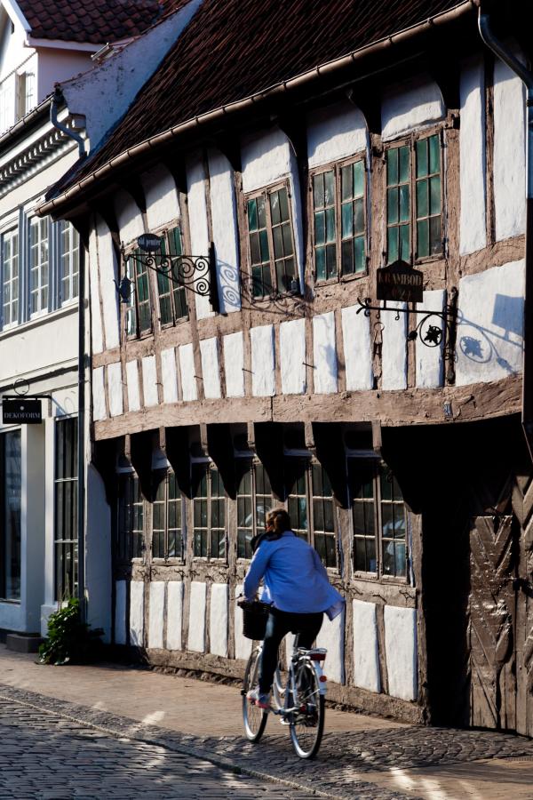 Cycling down an old street in Odense, Denmark