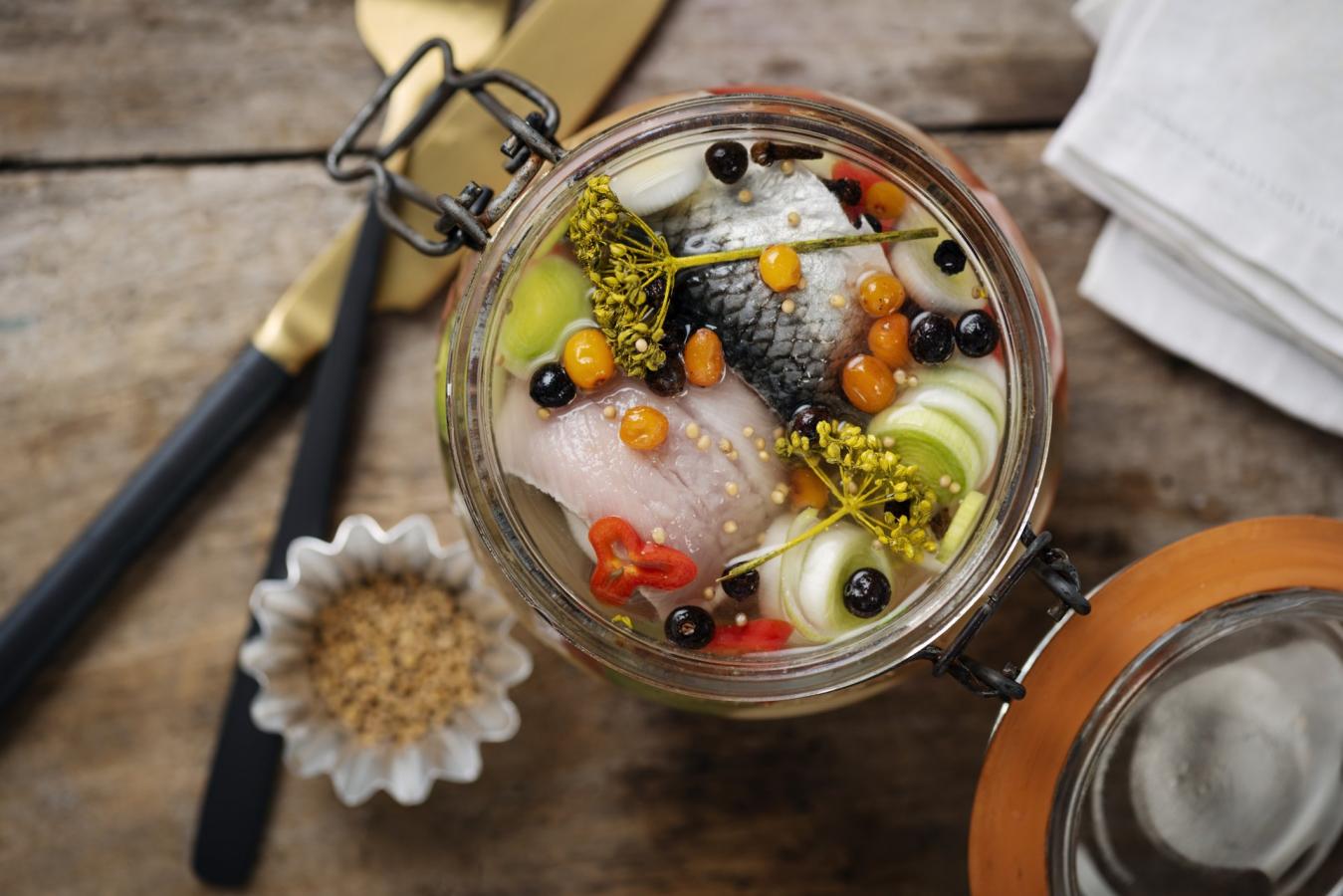 a glass jar filled with pickled herring in Denmark