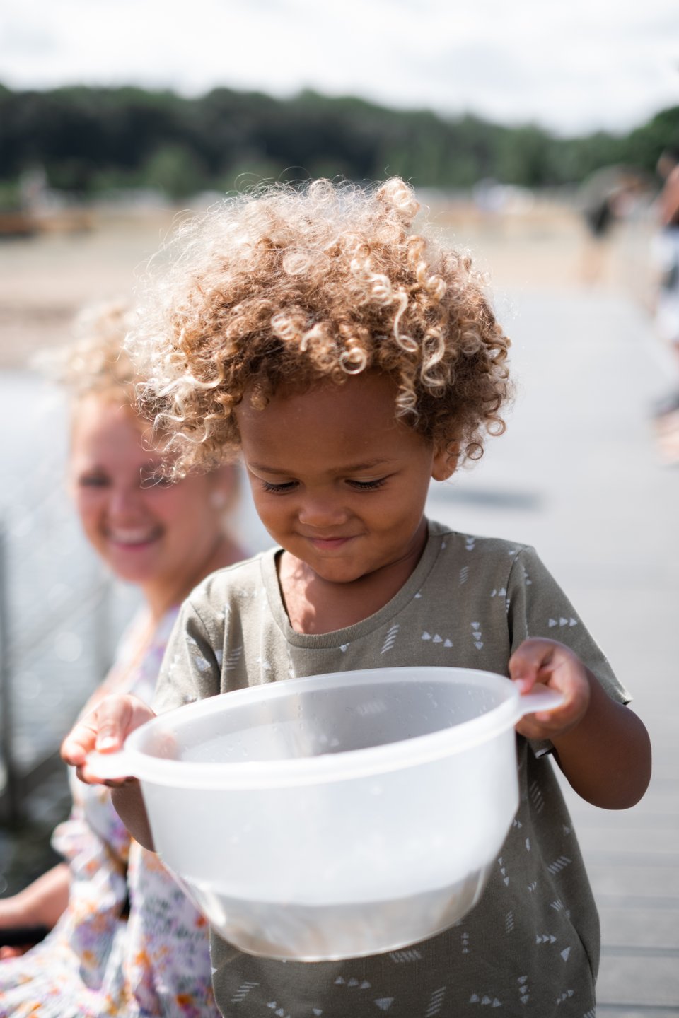 Child crab fishing with family at Mørkholt beach, Denmark