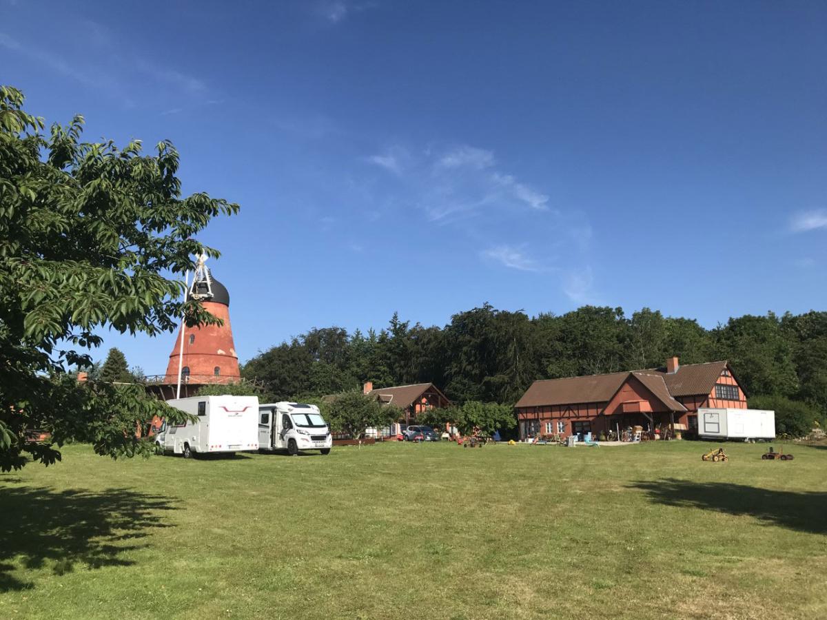 Ein Bild von einem Pintrip Stellplatz, das einen Hof, eine Mühle und zwei Autocampers zeigt