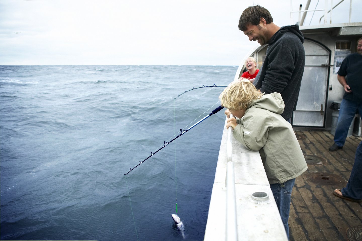 Family fishing from a boat in Denmark