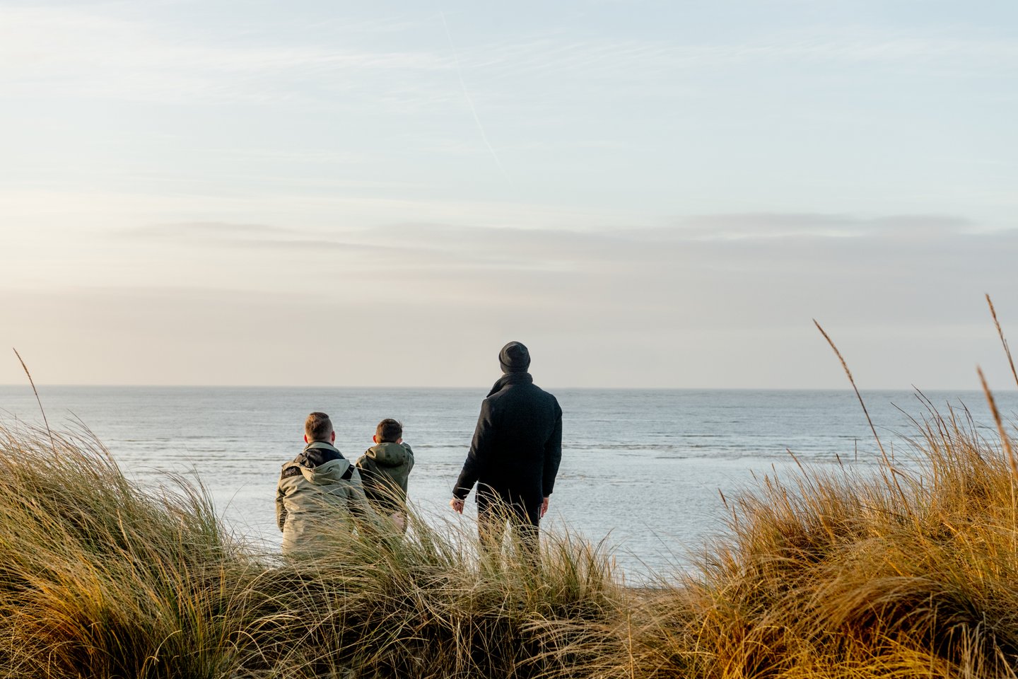 Family watching the sea on Blåvand beach in West Jutland