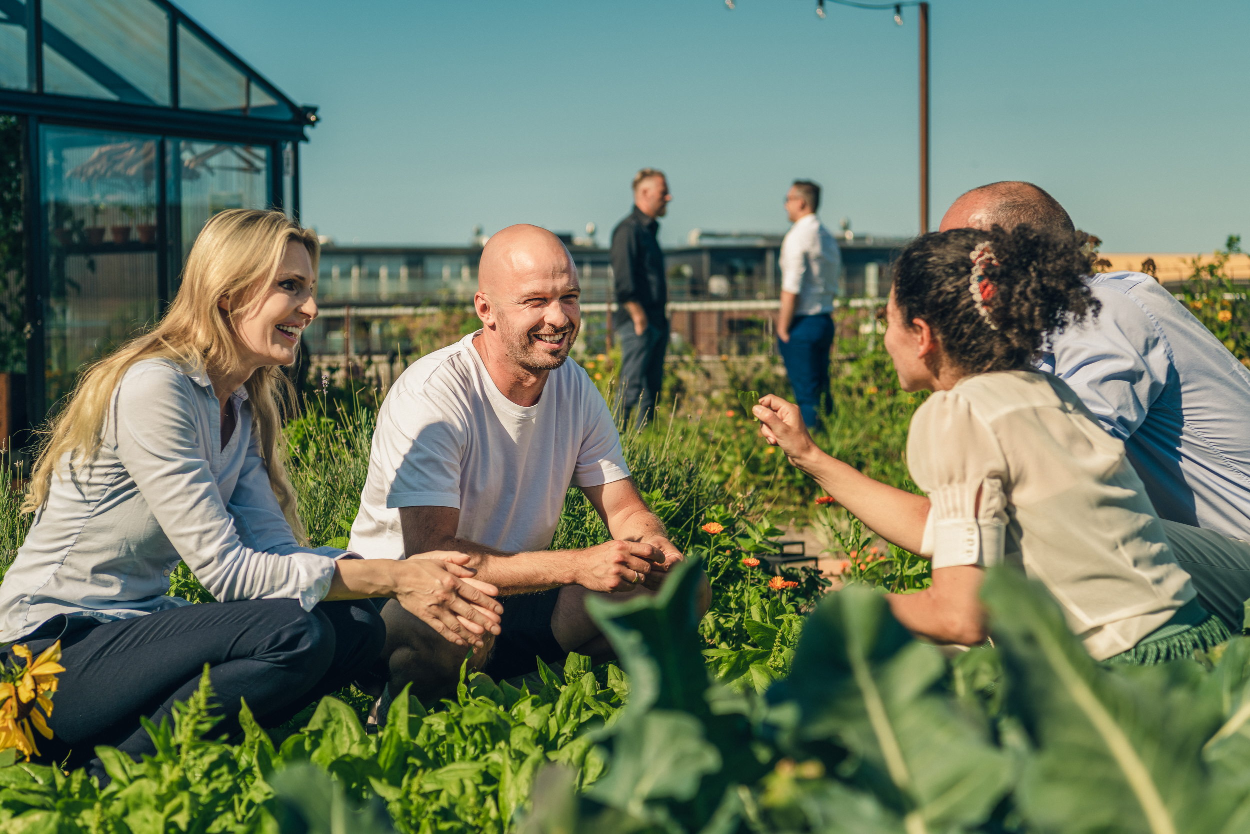 People interacting in the garden at Østergro