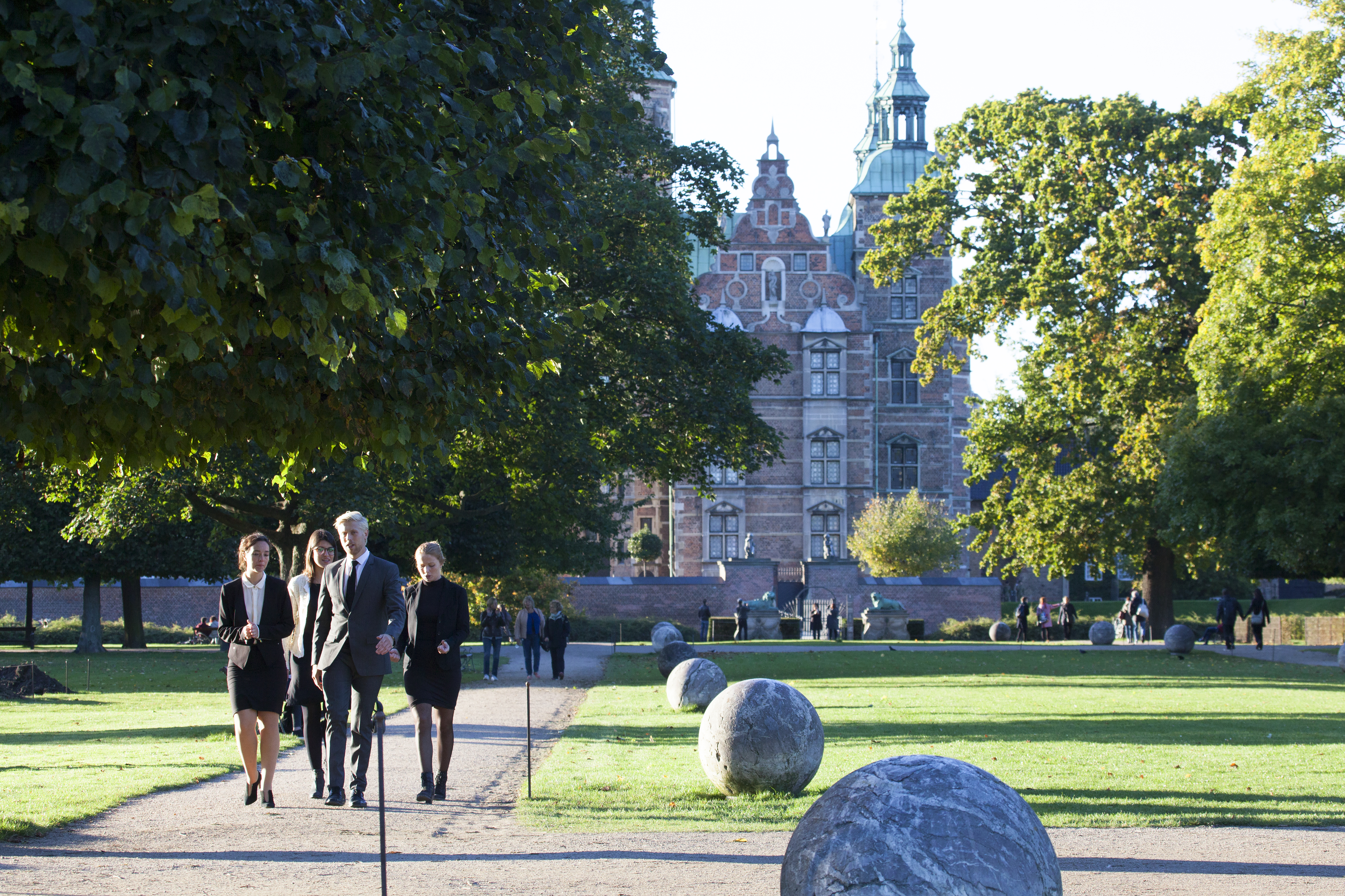People walking in King's Garden with Rosenborg Castle in the background