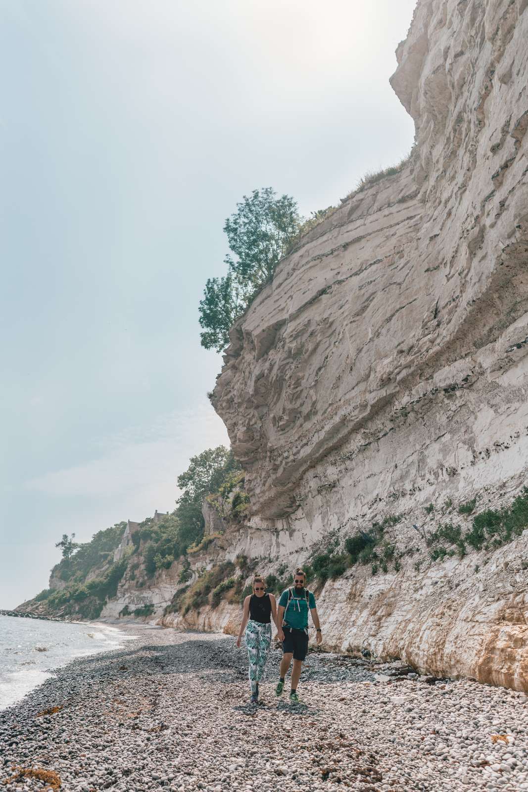 Couple hiking at the beach at Stevns Klint in South Zealand