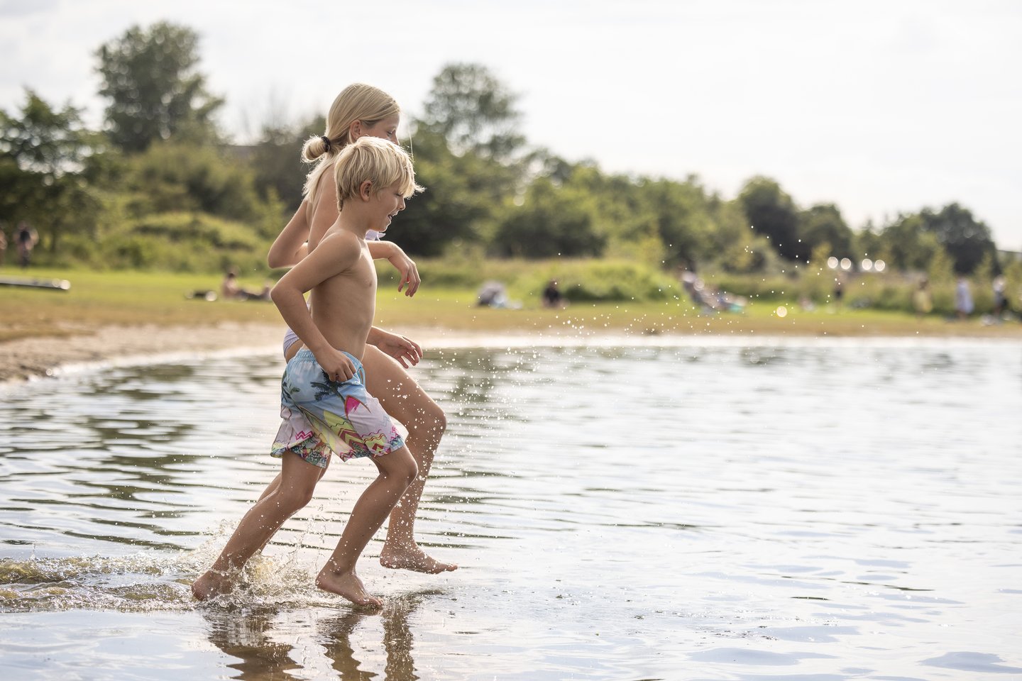 Children running in the water at the coast of North Jutland