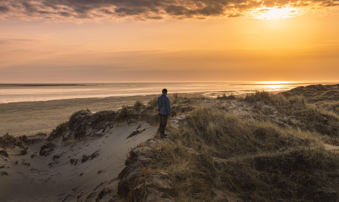 Man standing at the Wadden sea