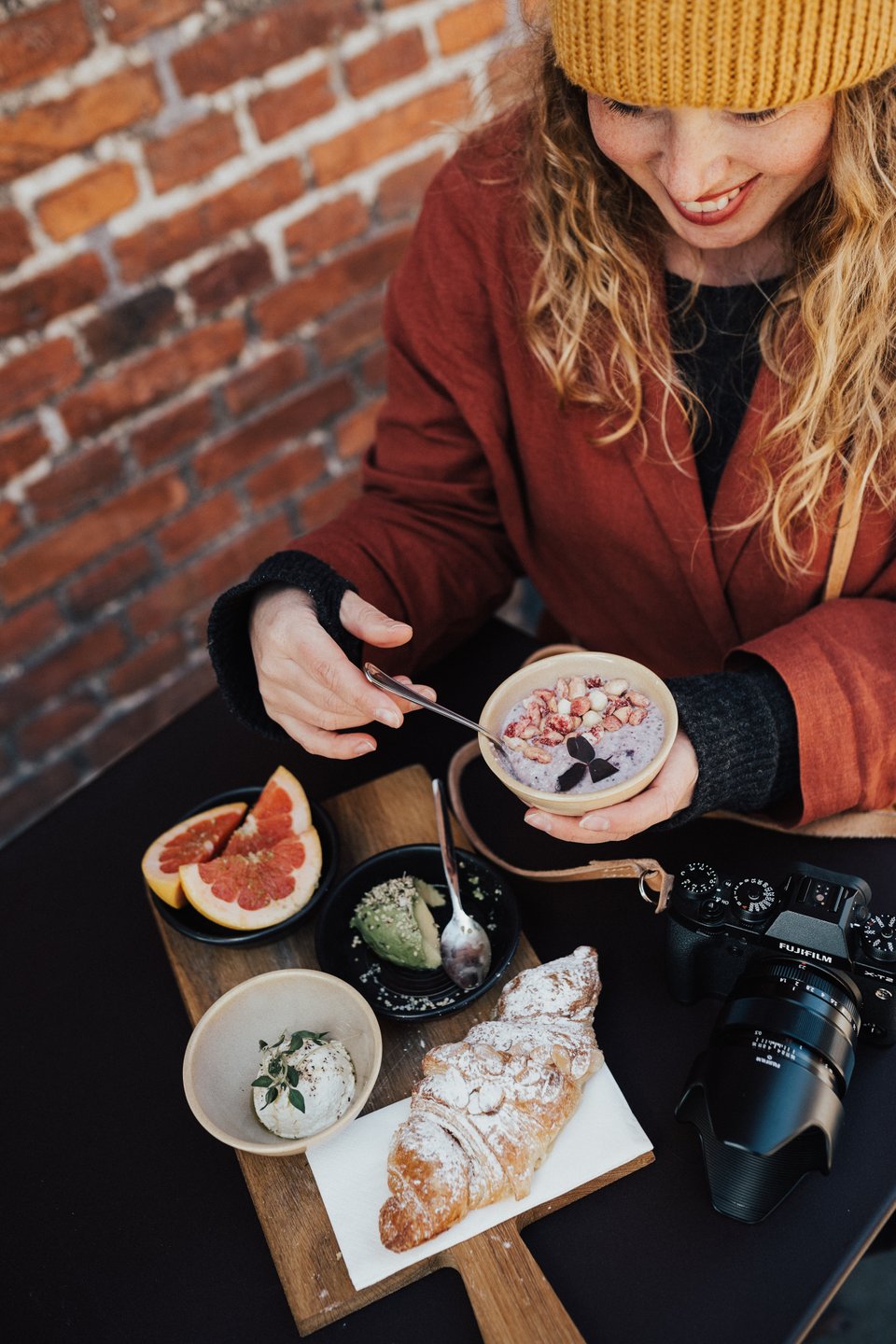 Woman having brunch outside in Copenhagen in autumn