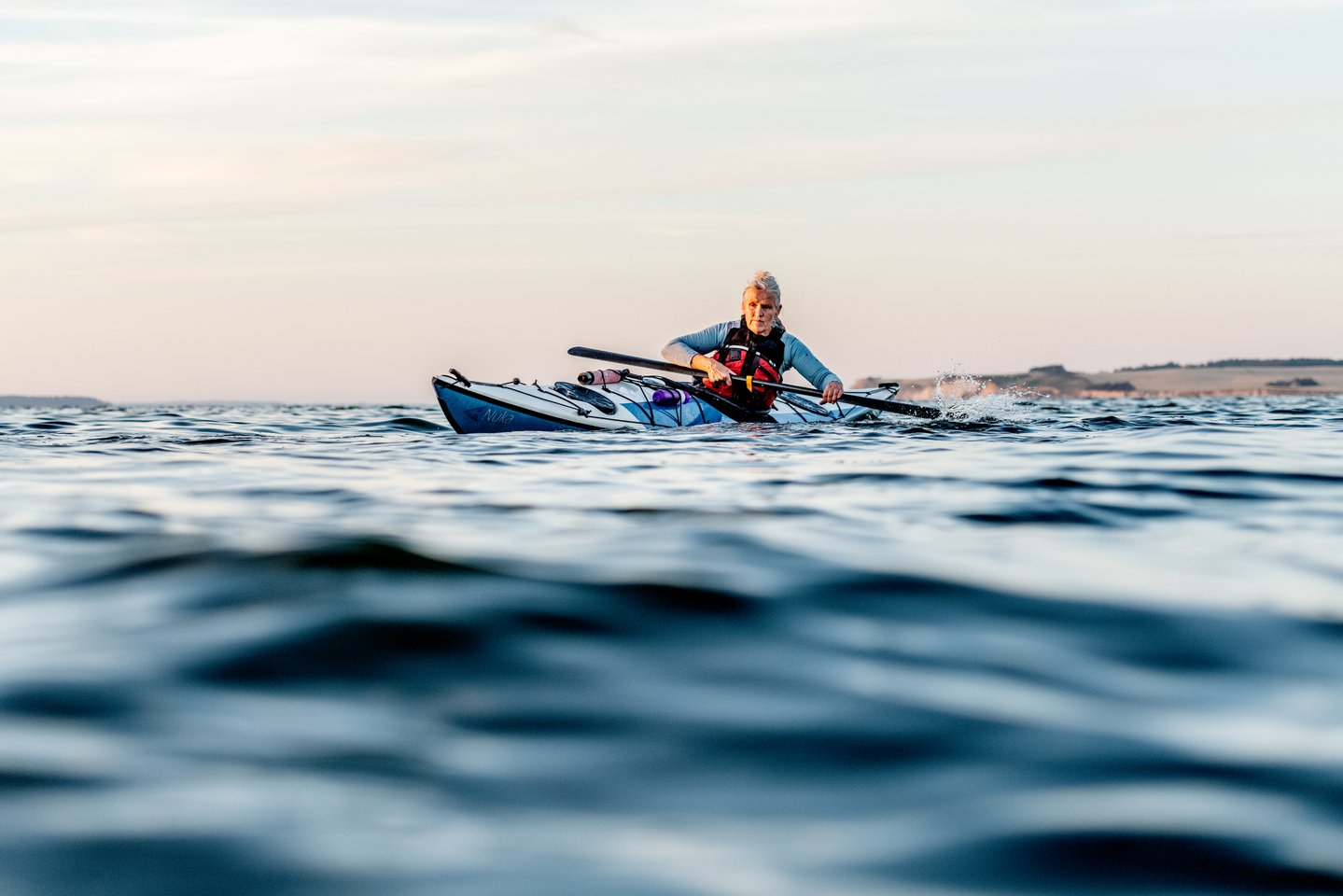 Kvinne i kajakk på vannet i Danmark