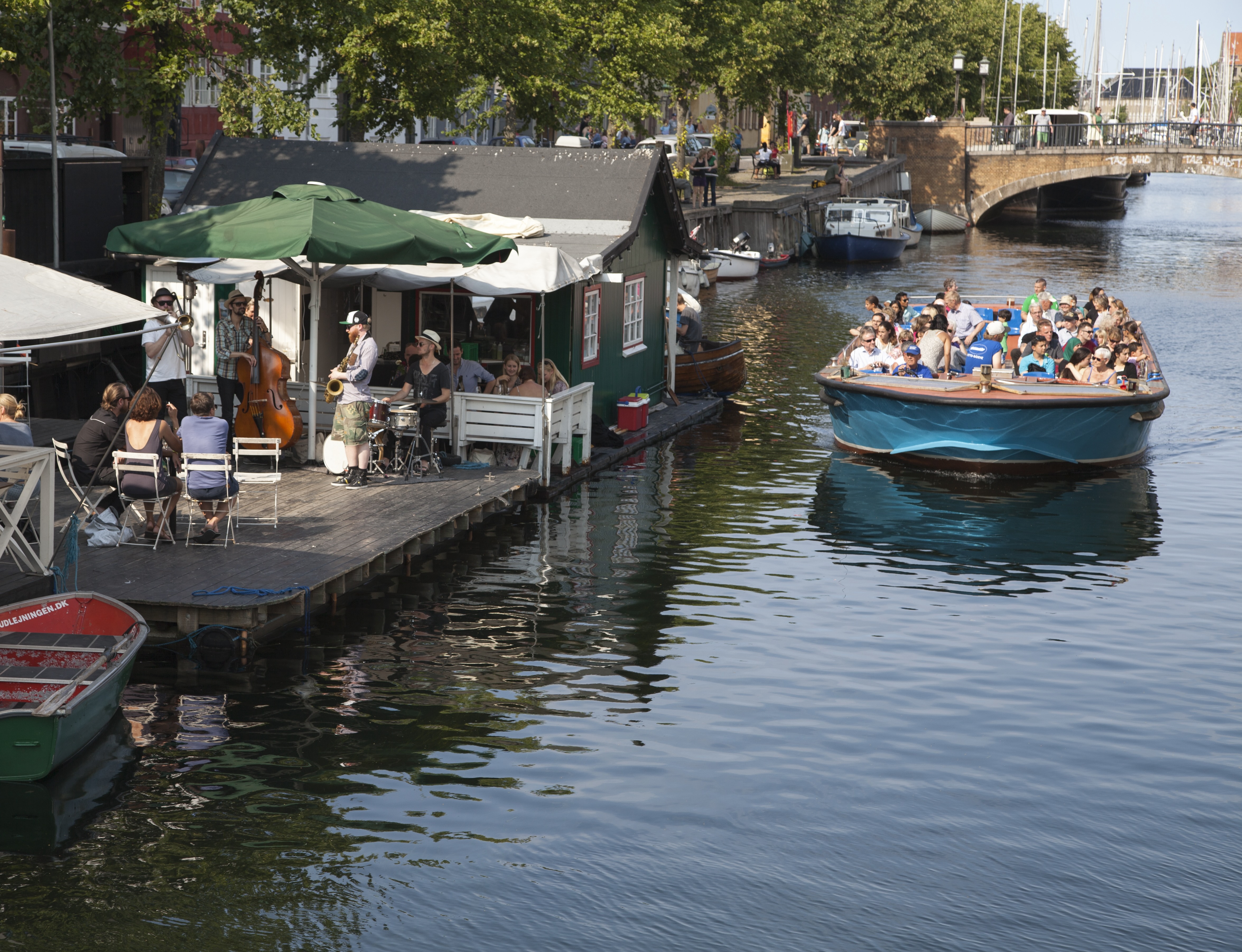 A floating bar and a canal tour boat on the Copenhagen canal