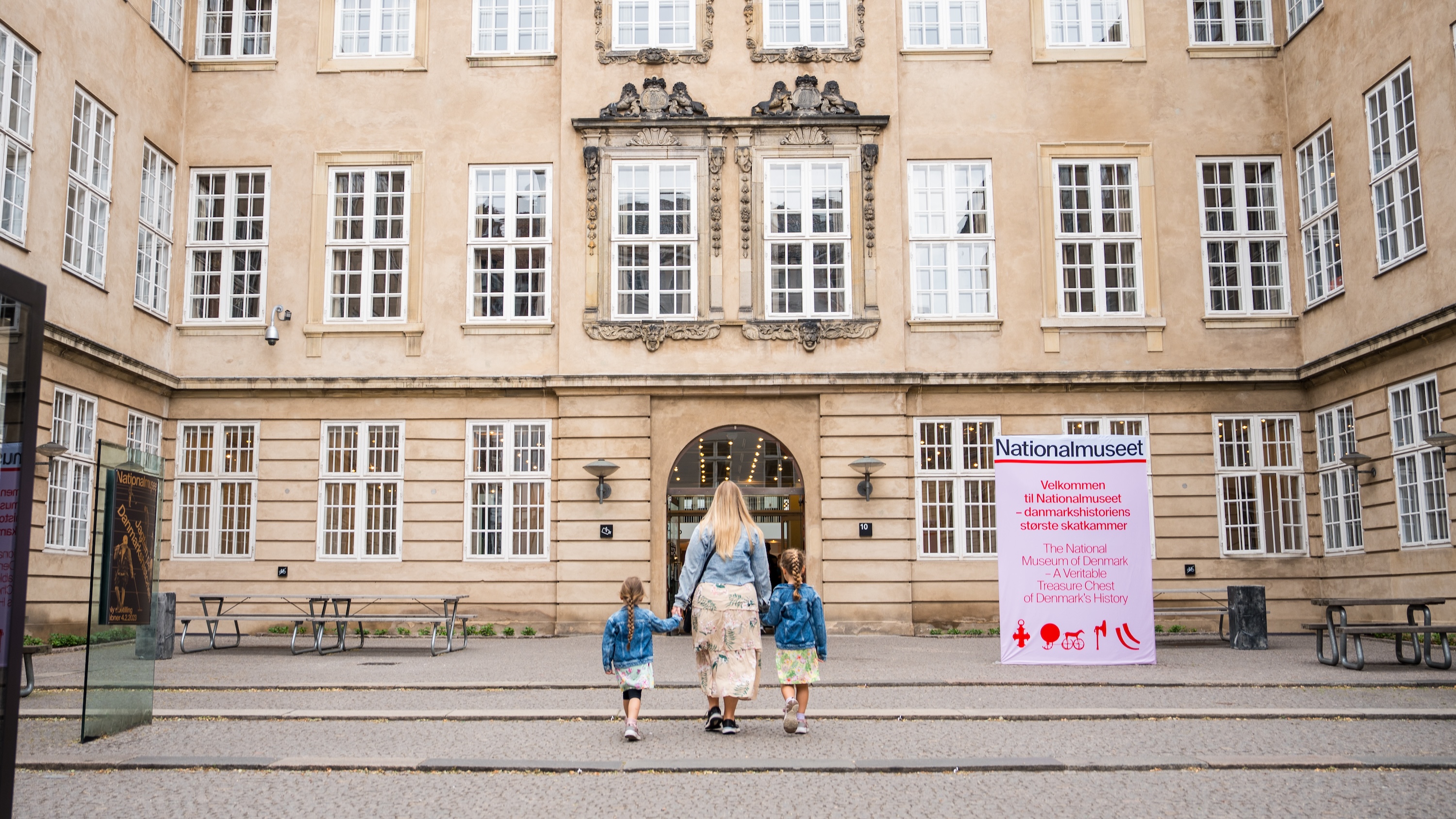 A mother and her two kids in front of the Danish National Museum