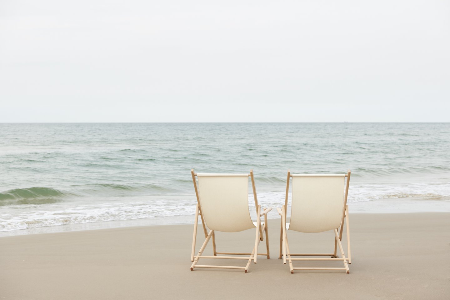 Two empty beach chairs on a beach near Hirtshals