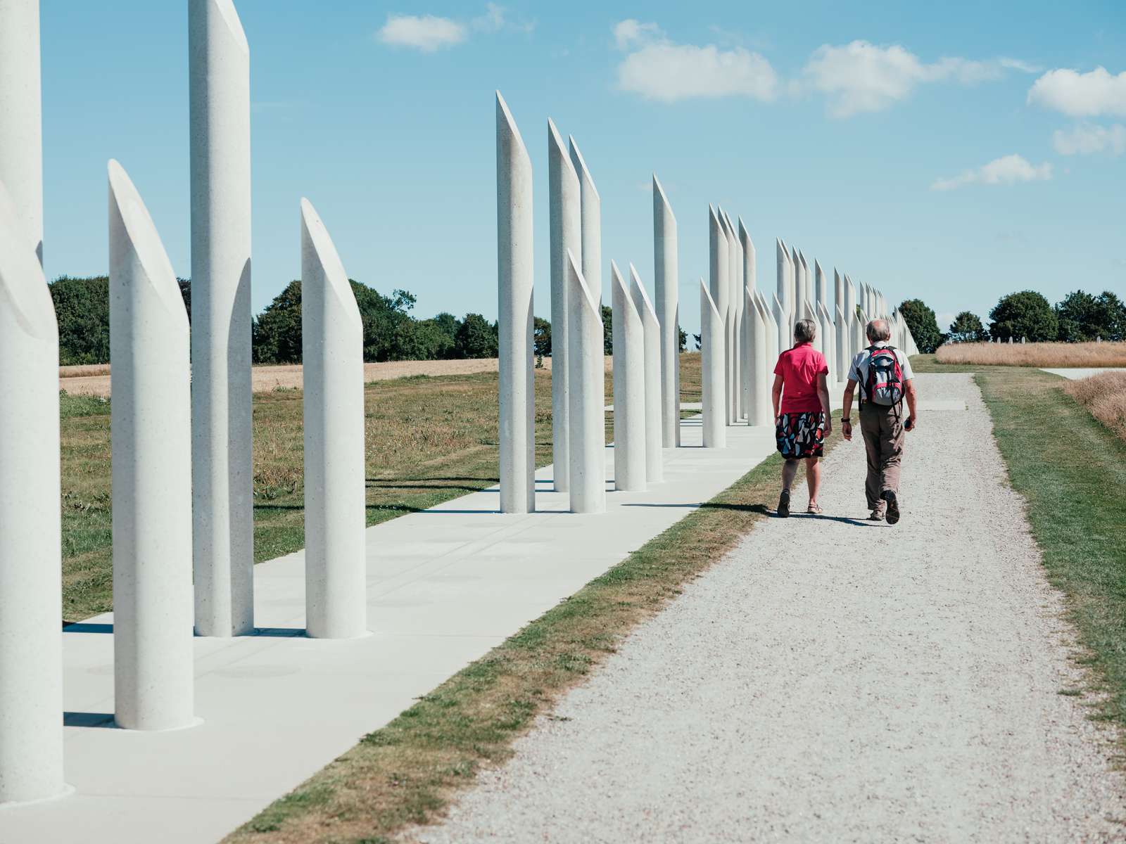 Couple walking along Jellinge monuments in Jutland