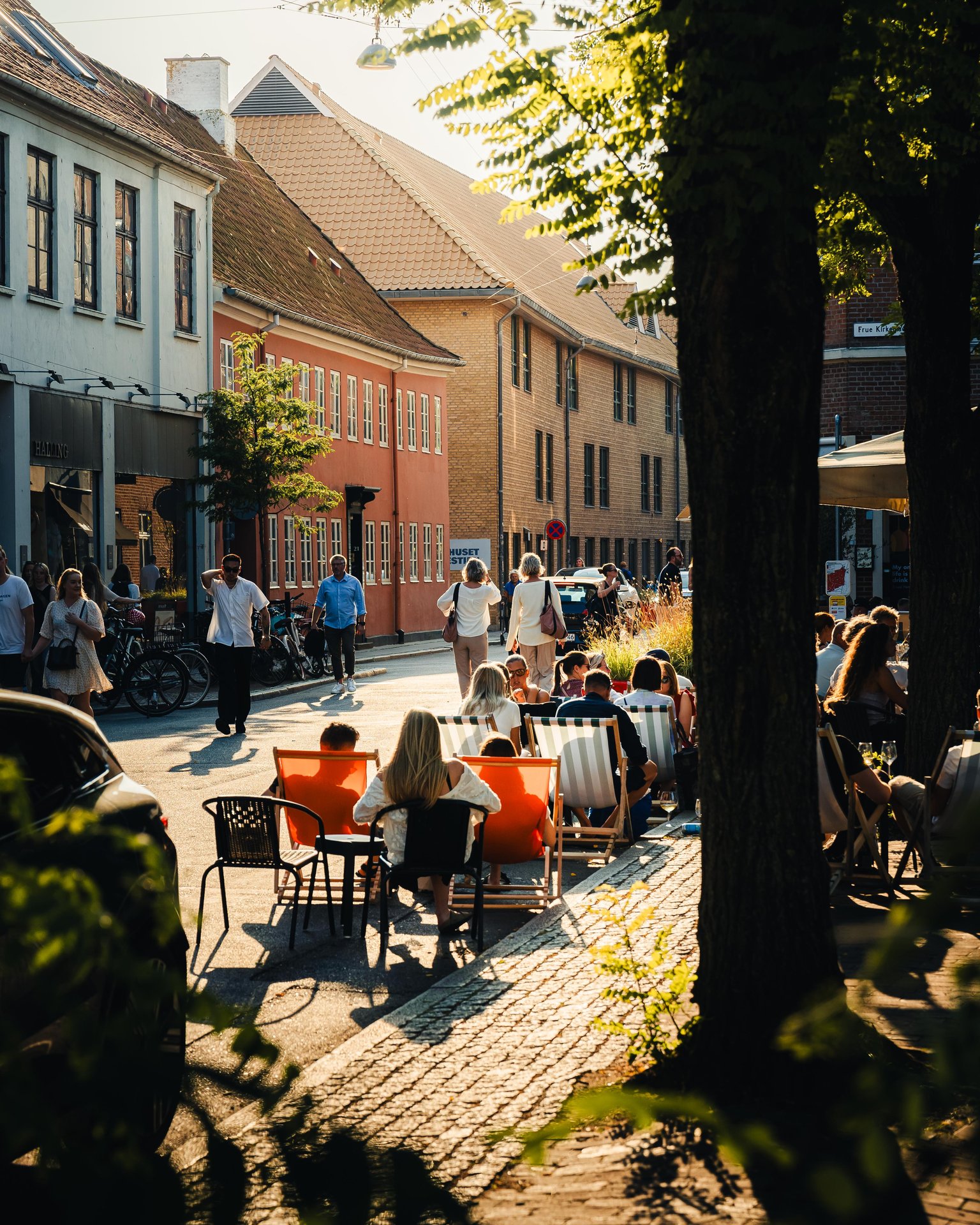 People sitting outside in Vestergade in Aarhus during summer