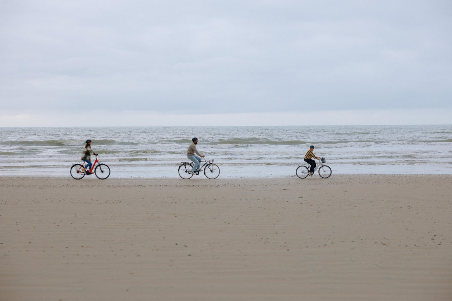 Family cycling on the beach of the Danish North Sea coast