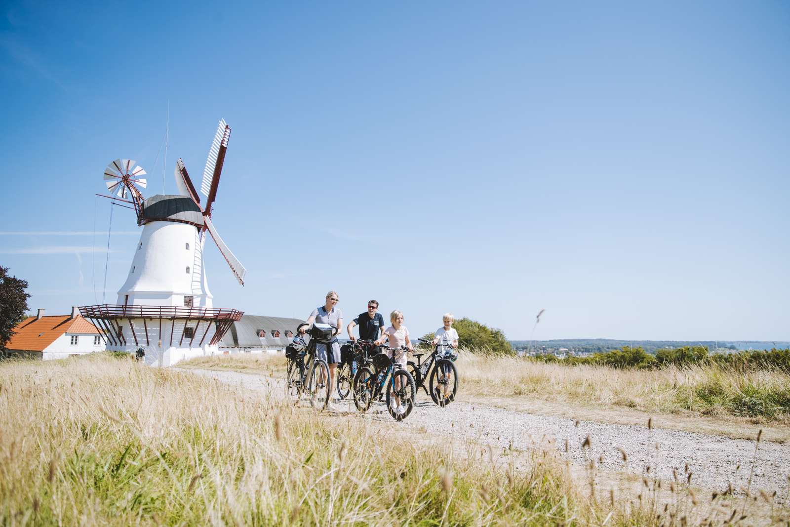 Family on bicycles by Dybbøl mølle in Sønderjylland
