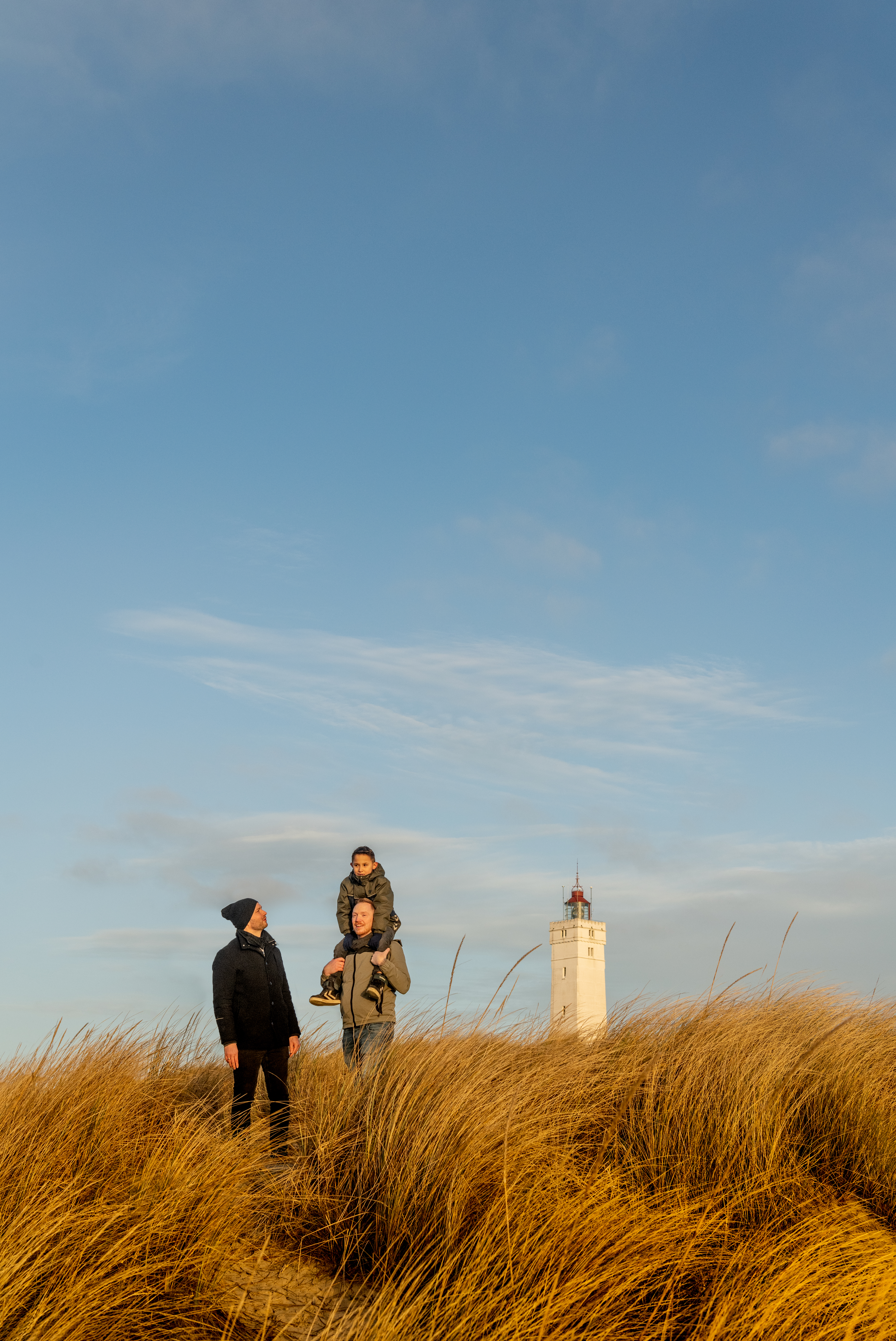 Couple and child at Blåvand Lighthouse.