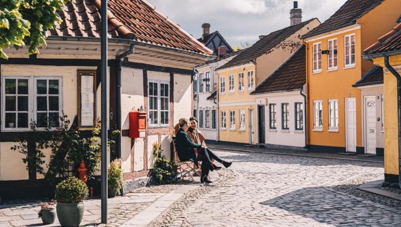Women sitting on a bench in old town of Odense on Fyn
