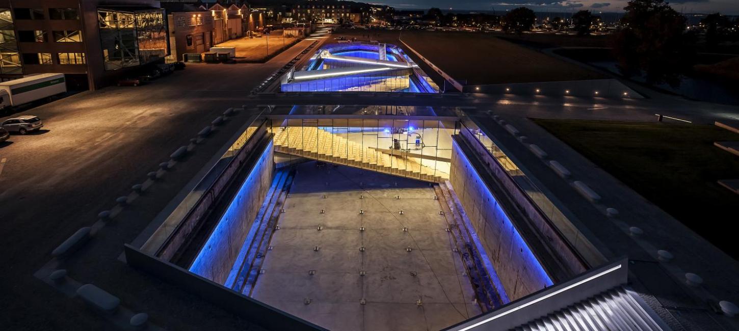 The Danish Maritime Museum in Helsingør, Denmark, lit up at night with neon lights