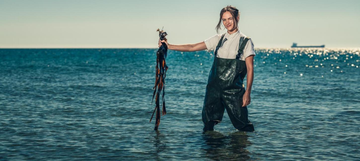 Chef Mathilde from restaurant Blink foraging seaweed by the beach in Skagen, North Jutland