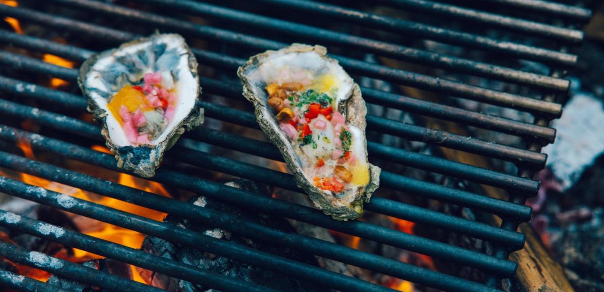 Oyesters on the grill with colorful topping 
