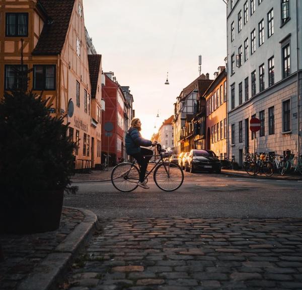 Girl biking in the neighbourhood of Christianshavn in Copenhagen