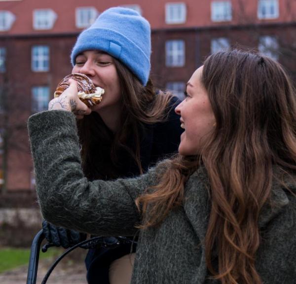 Person biting in Fastelavnsbolle in Copenhagen 