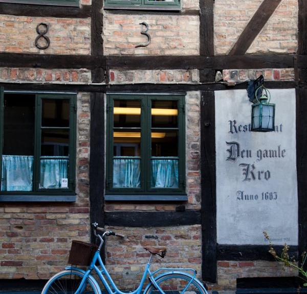 A bike leans against the wall of Den Gamle Kro, a pub in Odense, Denmark