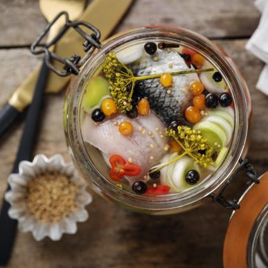 a glass jar filled with pickled herring in Denmark