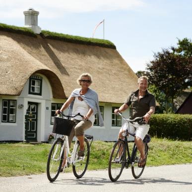 Couple cycling in Sønderho on island Fanø