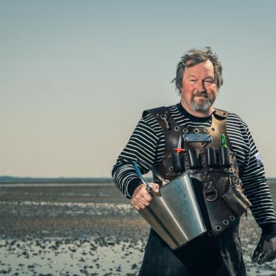 The Oyster King picking oysters in The Wadden Sea