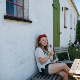 Woman enjoying an ice cream on a break from cycling,  BLÅBÆR GÅRDBUTIK  